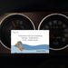 Cartoon card with humorous message on a car dashboard background