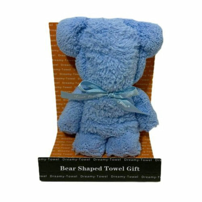 A blue plush bear-shaped towel gift sitting on an orange patterned insert with a black base label that reads 'Bear Shaped Towel Gift'.