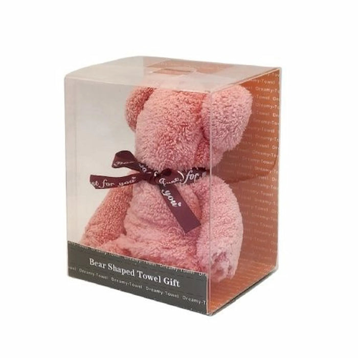 A pink teddy bear shaped bath towel gift inside a clear plastic display box with a dark ribbon bow, on a white background.