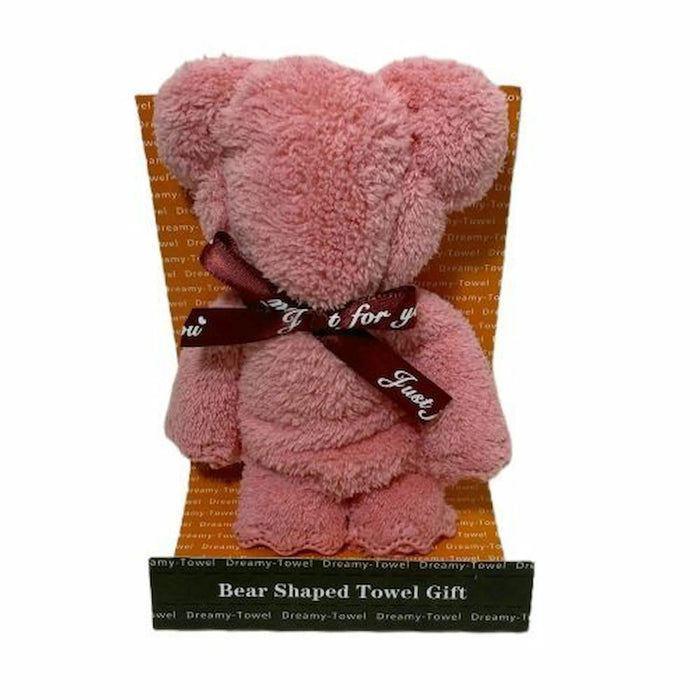 A pink plush bear-shaped towel gift displayed on a branded stand with a dark ribbon around its neck. The stand reads 'Bear Shaped Towel Gift' and shows the Dreamy Towel brand name.