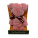 A pink plush bear-shaped towel gift displayed on a branded stand with a dark ribbon around its neck. The stand reads 'Bear Shaped Towel Gift' and shows the Dreamy Towel brand name.