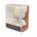 A bear-shaped cream-colored towel gift inside a clear plastic box with an orange patterned backing and a black label at the bottom. The towel features a white ribbon tied around the neck with black script text.