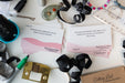 Desk with decluttering cards, ribbons, and other items on a white surface