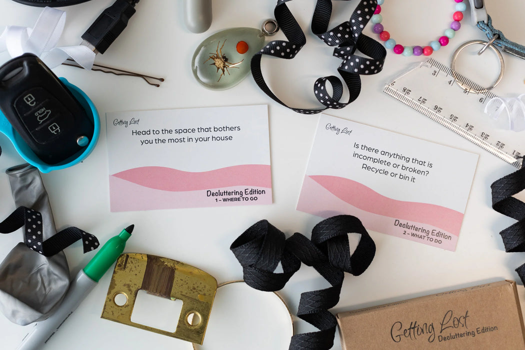Assorted items including ribbons, a hair clip, and cards on a white surface.