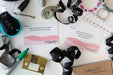Assorted items including ribbons, a hair clip, and cards on a white surface.