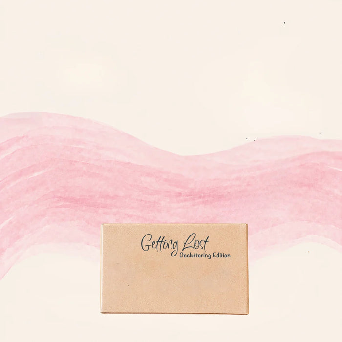 Product packaging with 'Getting Lost' branding on a pink and beige gradient background