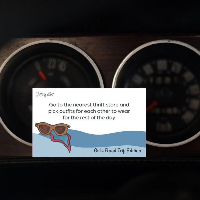 Card with sunglasses and scarf design on a car dashboard background