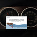 Card with sunglasses and scarf design on a car dashboard background