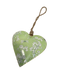 A heart-shaped decorative hanging ornament with a light green background, white floral and dragonfly pattern, and a natural jute hanging loop.