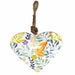 White metal heart decoration with colourful butterfly and botanical floral print, hanging from a jute rope loop