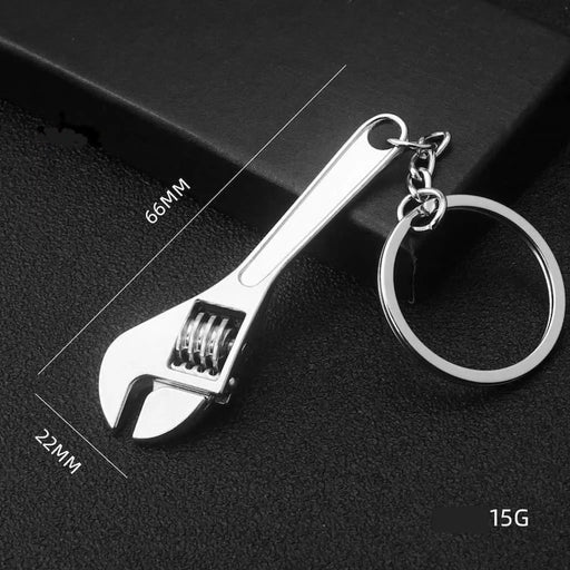 Metal wrench keychain on a dark background
