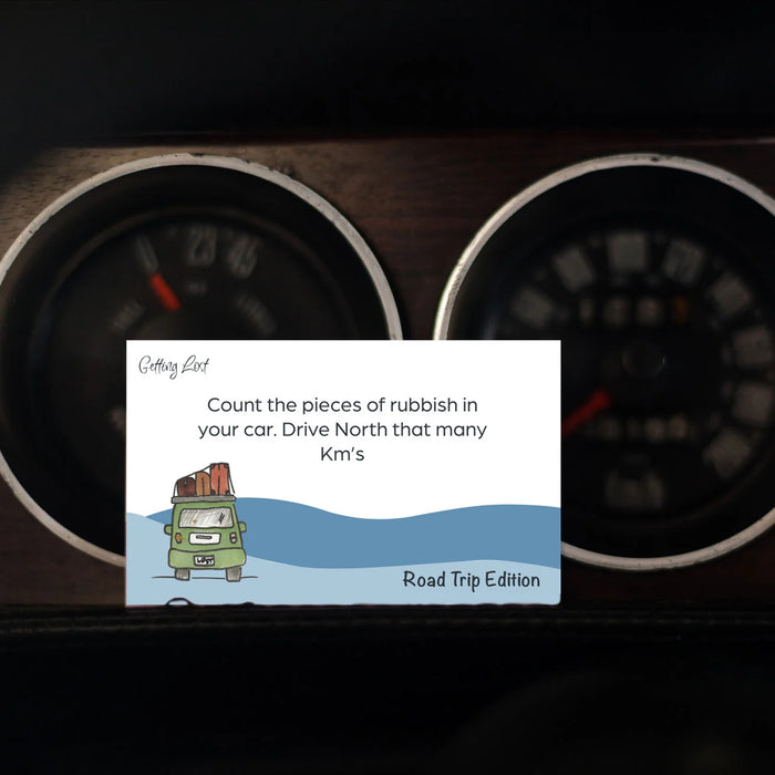 Car dashboard with a road trip-themed card on a dark background
