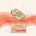A stylized illustrated product graphic showing a pair of yellow flip-flops above a small box labeled 'Getting Lost Summer Edition' on a cream background with coral brushstrokes and small star/dandelion doodles.