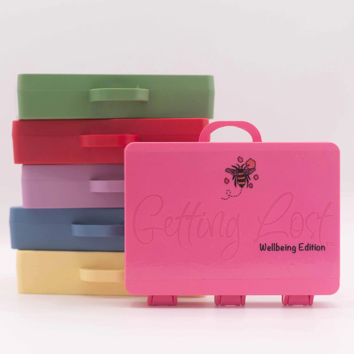 Stack of colorful plastic cases with 'Getting Lost' branding on a white background