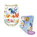 A stemless wine glass and matching gift box featuring a bluebird and colorful wildflower illustration. The glass has gold decorative trim, and the box is light blue with gold text and a gold dried citrus slice accent.