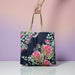 Blush Beauty reusable poly-linen tote bag with a pink watercolour floral print, held up by a hand against a plain background