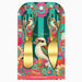 A decorative cheese knife set in its retail packaging, featuring two gold-colored cheese knives with handles printed with a colorful kookaboo and floral design on a teal and pink striped background.