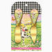 A cheese knife set in retail packaging, featuring two gold-colored cheese knives with decorative handles. The handles are decorated with a whimsical illustration of a black-and-white cow, butterflies, flowers, and a pastel sky.