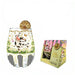 A clear stemless wine glass with a cow-and-floral print, shown next to its retail packaging box. The glass is decorated with a black-and-white cow, white daisies, butterflies, gold hearts, and black-and-white gingham accents at the base, and is garnished with a dried lime slice.