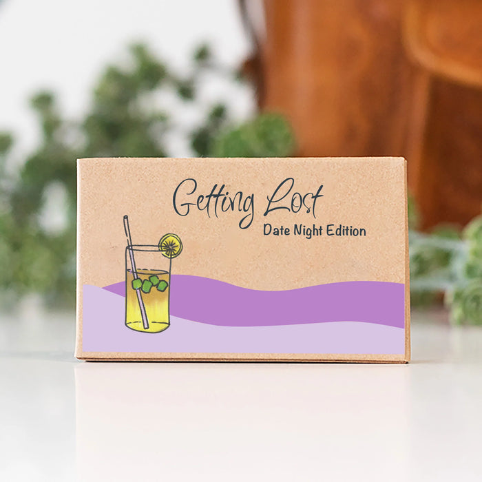 Box labeled 'Getting Lost Date Night Edition' with a drink illustration on a blurred background