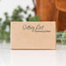 A small kraft paper box with the words 'Getting Lost' and 'Decluttering Edition' printed on the front, photographed on a white surface with a softly blurred indoor background.