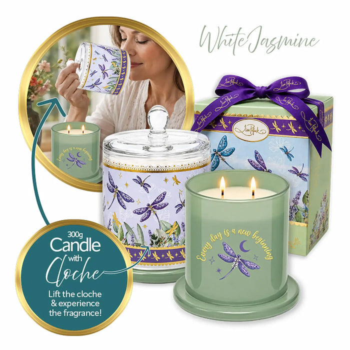A white jasmine scented candle set by Leioh, featuring a sage green double-wick candle with a dragonfly design, a matching glass jar with lid, a purple ribboned gift box, and a circular inset showing a woman drinking from a matching mug.