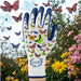 A white and navy blue gardening glove with colorful butterfly prints on the back, shown against a garden background with flowers and butterflies. The brand logo 'FunJobs Garden Gloves' is visible on the wrist.