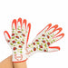 A pair of white knit gardening gloves with bright orange palms, fingers, and cuffs, decorated with a colorful pattern of ladybugs, leaves, and flowers. The gloves are being worn on hands, with the Funloaf brand logo visible on the wrist.