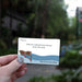 A hand holds a small printed card that reads 'Stop at a playground and go down the slide' with the phrase 'Girls Road Trip Edition' at the bottom. The card has a white background with a blue wave illustration and an illustration of red-and-yellow sunglasses.