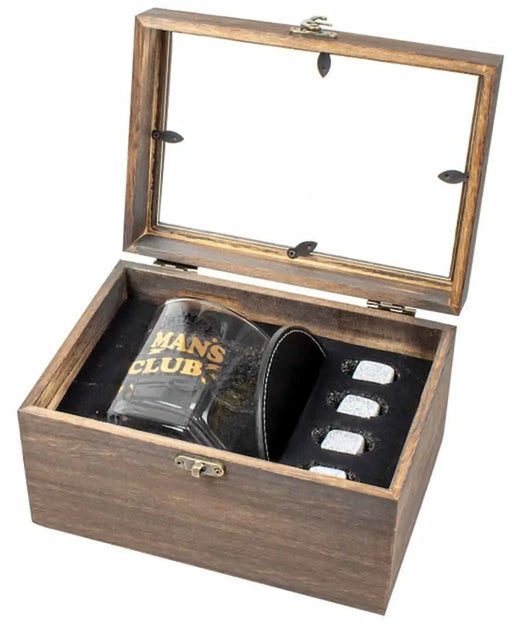 A wooden presentation box with a glass-look lid, shown open on a white background. Inside are a dark glass tumbler with gold lettering reading 'MANS CLUB', a black leatherette sleeve, and four small silver-toned rectangular pieces.