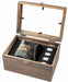 A wooden presentation box with a glass-look lid, shown open on a white background. Inside are a dark glass tumbler with gold lettering reading 'MANS CLUB', a black leatherette sleeve, and four small silver-toned rectangular pieces.