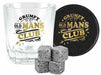 A clear rocks glass with a 'Grumpy Old Mans Club' graphic, a matching round black coaster with gold lettering, and four gray ice cubes on a white background.