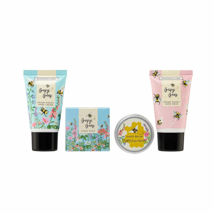 A set of three hand and body care products from The Happy Honey Bee: a blue tube of Vegan Honey Hand Cream, a pink tube of Vegan Honey Hand Wash, and a round tin of Organic Beeswax Hand Balm, arranged on a plain white background.