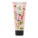 A pink tube of Heathcote & Ivory Busy Bees Vegan Honey Hand Cream, decorated with illustrations of bees and wildflowers, on a white background.