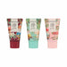 Three tubes of Dr. Lush 'In the Garden' hand butter shown side by side on a white background, featuring colorful fairy illustrations and different cap colors: dark red, mint green, and light pink.