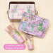 Cosmetic set with floral design on a light yellow background, featuring 'Sweet Pea' branding.