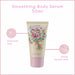 Smoothing body serum tube with floral design on a pink background