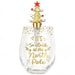 A clear stemless wine glass with gold foil text reading 'IT'S 5:00 at the North Pole' and gold star/snowflake accents, topped with a gold Christmas tree ornament featuring a red star.
