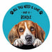 A circular coaster featuring a painted beagle dog with the text 'ALL YOU NEED IS LOVE - AND A BEAGLE' and black paw prints on a bright blue background.