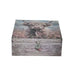 A rectangular decorative box with a rustic wood-grain finish, featuring a printed highland cow and wildflower design on the lid and front, with a small tassel ornament on the clasp, shown against a plain white background.