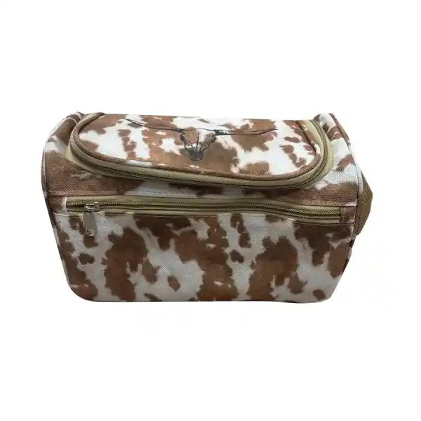 A brown and white cow-print zippered bag with a flap top and gold-toned zipper hardware, shown against a plain white background.