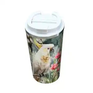 A white insulated travel tumbler with a flip-top lid, featuring a printed illustration of a white cockatoo perched among pink flowers and green foliage.