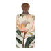 A rectangular wooden serving board with a rounded top handle, featuring a botanical print of a large cream and peach flower with green leaves on a light background.