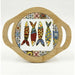 A round wooden serving board with two side handles and a central white panel featuring four colorful fish illustrations surrounded by a patterned border.