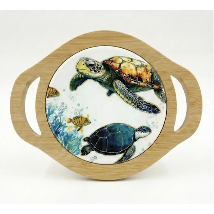 A round decorative serving platter with a light natural wood rim and integrated side handles, featuring a printed ocean scene with sea turtles and small fish on a white background.