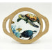 A round decorative serving platter with a light natural wood rim and integrated side handles, featuring a printed ocean scene with sea turtles and small fish on a white background.