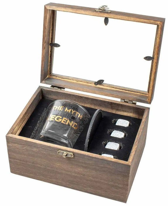 A wooden presentation box with a glass lid, containing a dark tumbler engraved with 'THE MYTH LEGEND' and a black leatherette pouch holding four silver-toned rings, on a white background.