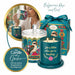 A decorative teal scented candle set with a glass jar candle, a lit candle in a teal holder, a matching gift box with a blue ribbon, and a circular inset showing a woman holding a matching candle. The packaging and labels feature kookaboo and floral artwork, with text reading 'Bulgarian Rose and Oud' and 'Life is better when you're laughing.