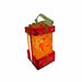 Red light-up Christmas gift box ornament with gingerbread man face and lollipop swirl