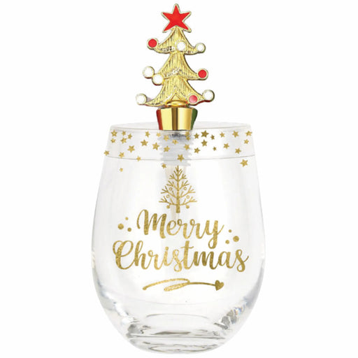 A clear stemless wine glass with gold 'Merry Christmas' lettering and a gold tree design, topped with a gold Christmas tree ornament featuring a red star and red ornaments, on a white background.